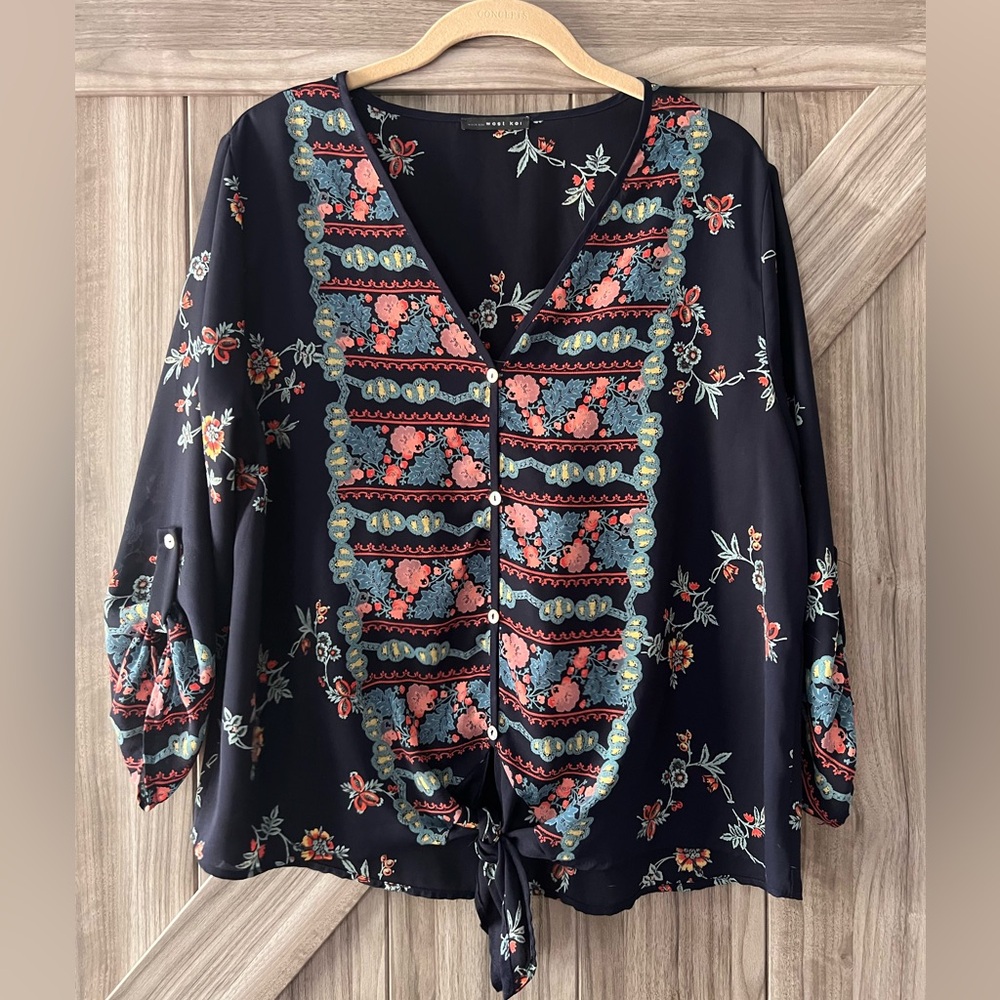 West Kei, blue blouse with beautiful floral pattern, button and tie details.